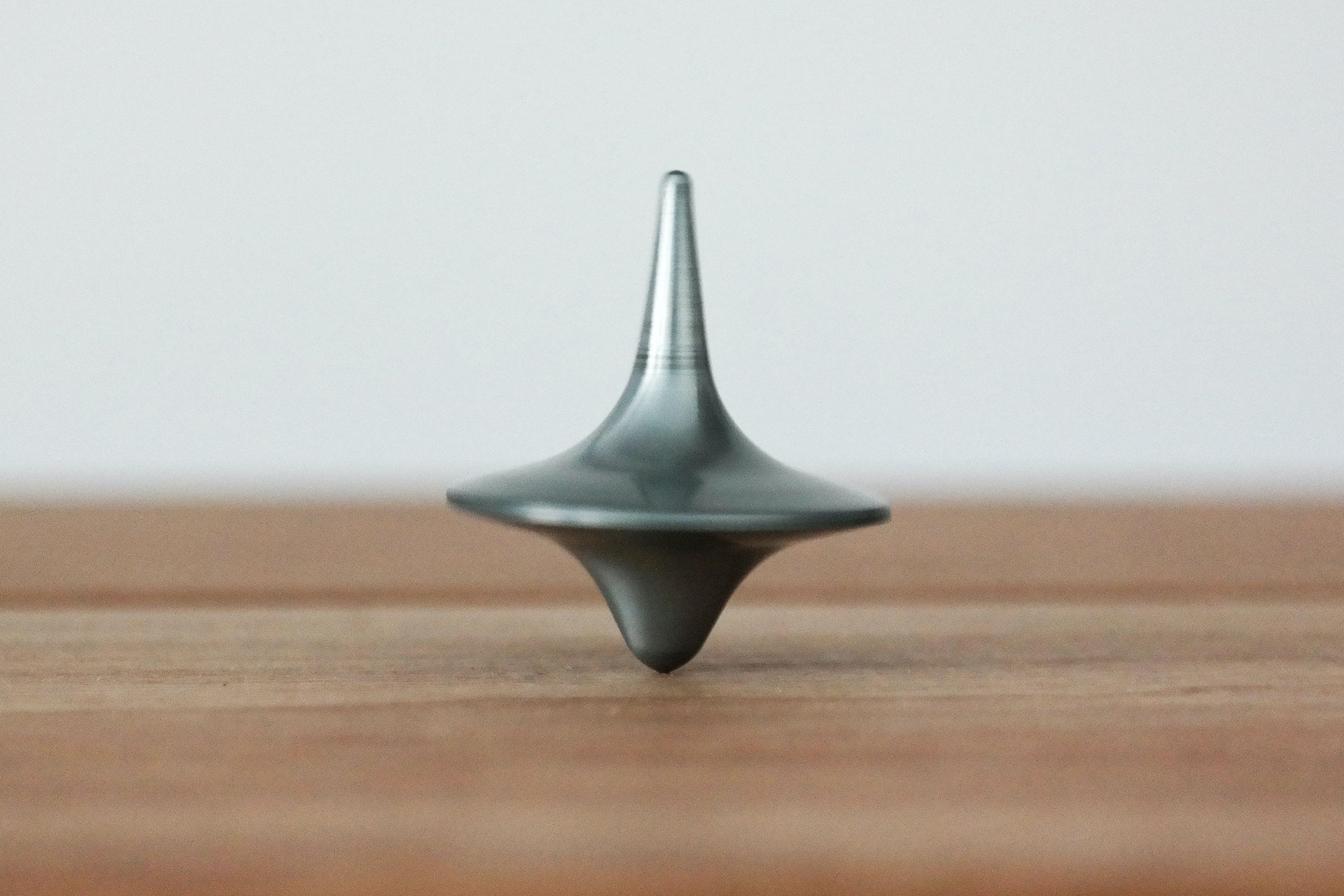 Image of a spinning top on a wooden surface